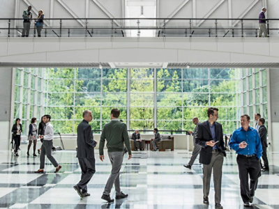 A group of people walking in a large room.