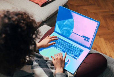 Overhead view of a person using a laptop with a blue and purple screen overlay.