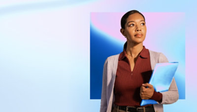 A women holding a tab and looking into her bag.