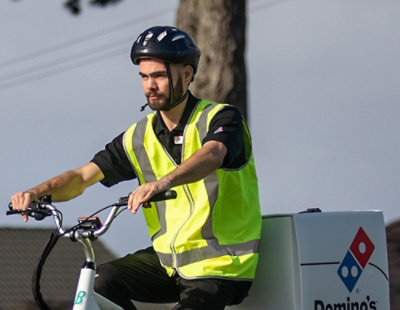 A man wearing a helmet and riding a cycle.