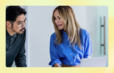 A women showing something on screen to a man.