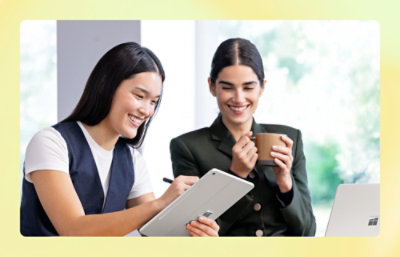 A women showing something on tab screen to other women.