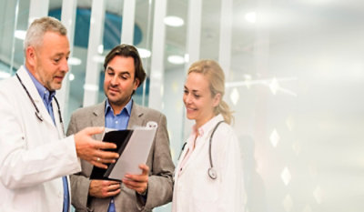 Two doctors discussing while looking at the reports