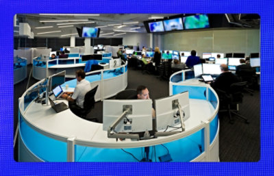 Image of a workplace where people are working on their respective systems