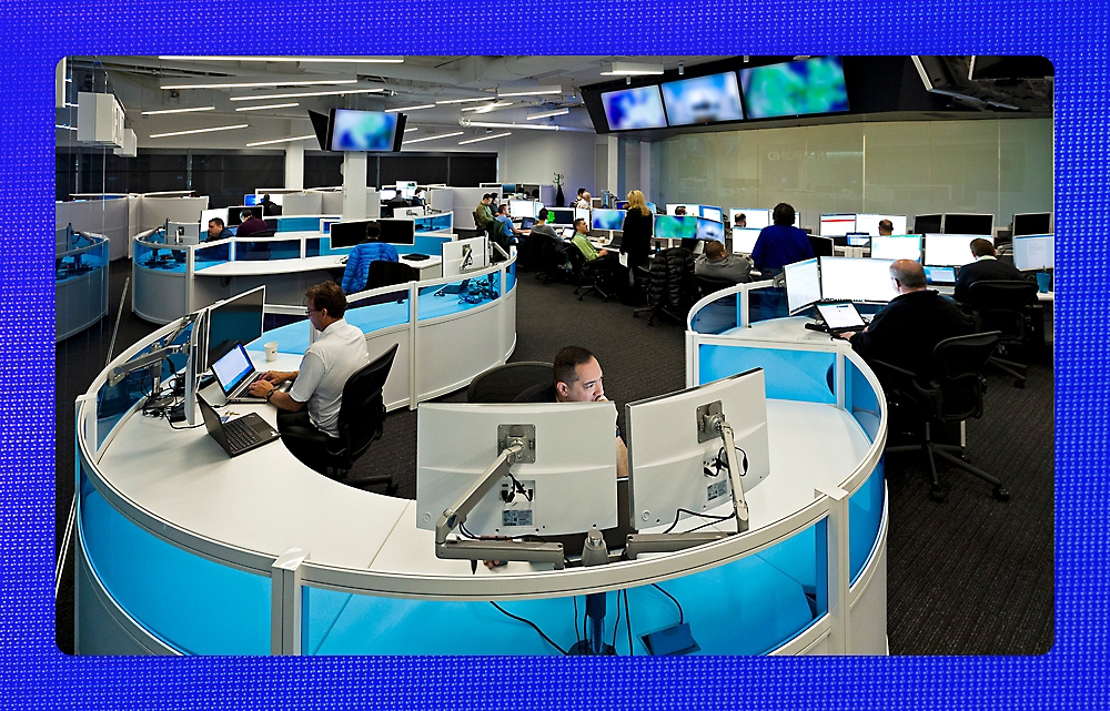 Image of a workplace where people are working on their respective systems