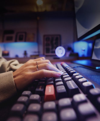 A hand typing on a keyboard.