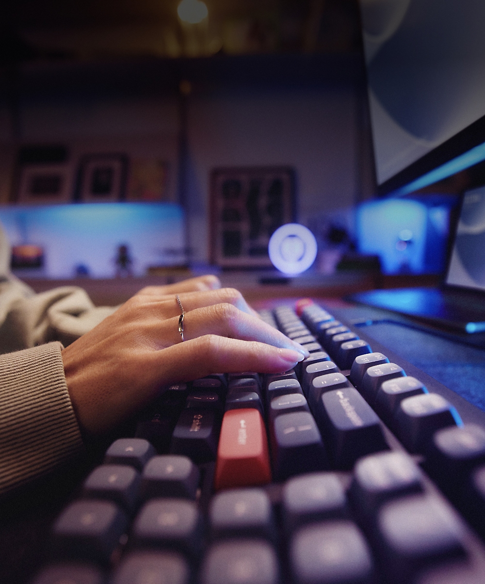 A hand typing on a keyboard.