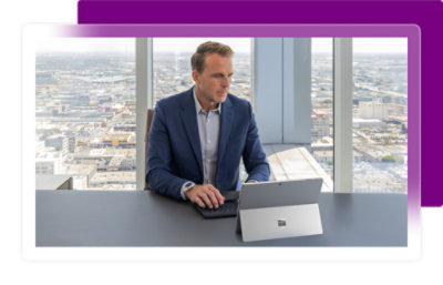 A man sitting at a desk with a laptop