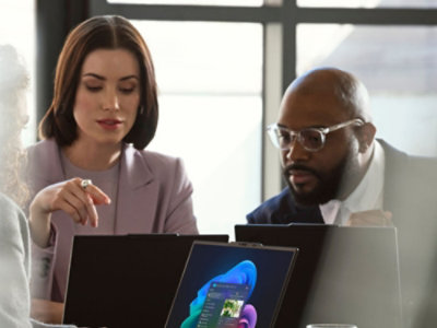 Two people talking to each other while looking at the screen.