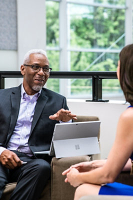 A man and woman sitting and talking to each other.