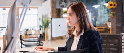 A woman looking at a laptop.
