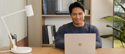 A man sitting at a desk with a laptop.
