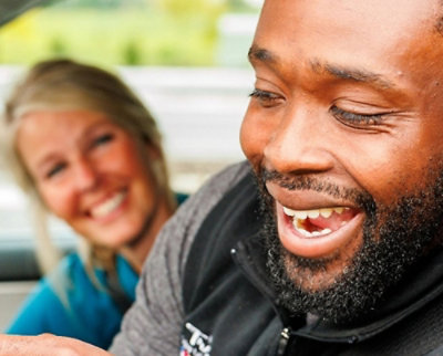 A men and women smiling.