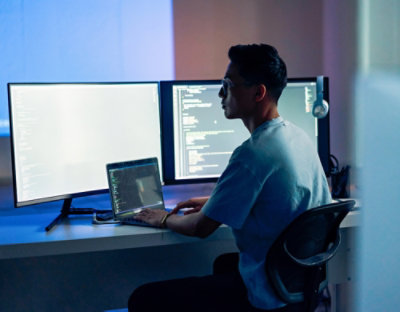 Developer working on dual monitors