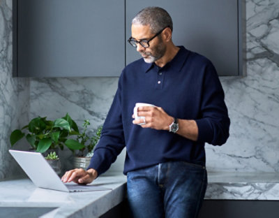 Man using laptop in kitchen