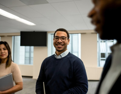 Team members standing in office discussion
