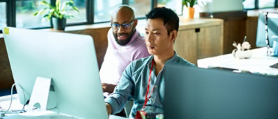 A group of people sitting and looking at monitor