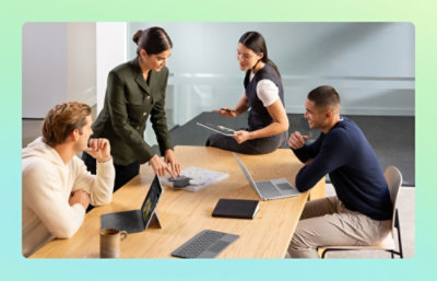 Team collaborating around a table with devices
