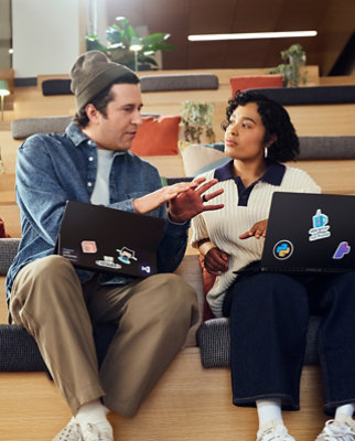 A men and woman looking at a laptop.