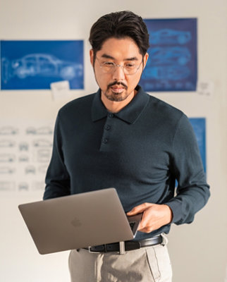 A man holding a laptop.