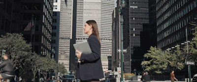 A women holing a laptop.