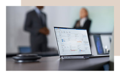 A laptop on a table displaying the number ١٠٠ on its screen.