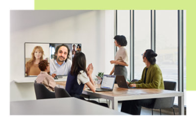 Team meeting with in-person and video call participants.