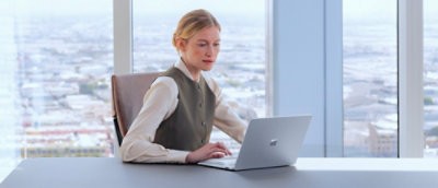 Woman sitting on chair and using laptop.