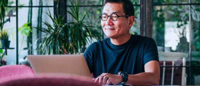 A man sitting on chair and using laptop