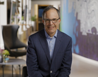 A person in a suit sitting in a chair