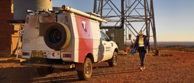 A white and red van with a white and red stripe on the back.