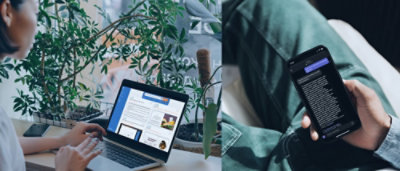 A person using a computer and another watching mobile