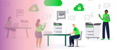 A man and woman sitting at a desk with a green and white sign in the background.