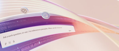 A close-up of a computer screen displaying the text Ask a work question or use / to reference people, ties and news.