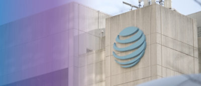 A white tile wall with a vent.