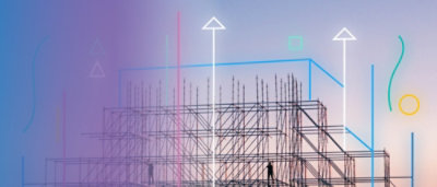 A group of people standing next to a building and scaffolding.