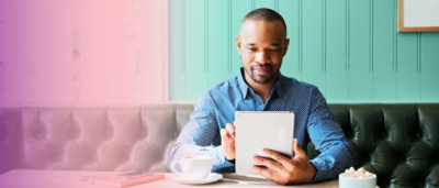 A person sitting at a table with a tablet