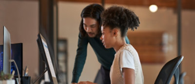 A man and women working on computer.