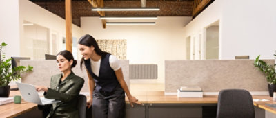 A woman sitting on a desk.