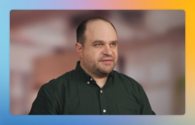 Person speaking on camera in a studio setting