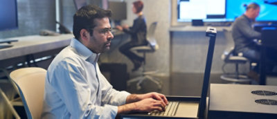 A man working on the laptop in office environment