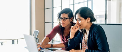 A man and women working on computer.