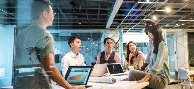 A group of people working around the table.