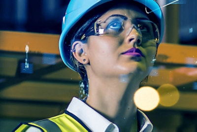 A person wearing a hard hat and safety glasses.