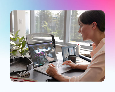 A woman sits at her desk, engaged in a video conference call on her laptop, with a coffee mug