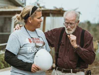 A man and a woman standing next to each other, with visible text reading STEAM and PRUBICON.