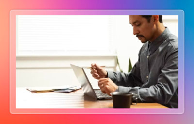 A person sitting at a desk using a laptop.