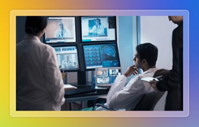 Clinical team analyzing medical scans and patient information across several monitors.