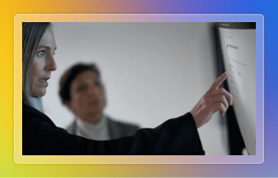 A person pointing at data on a screen.