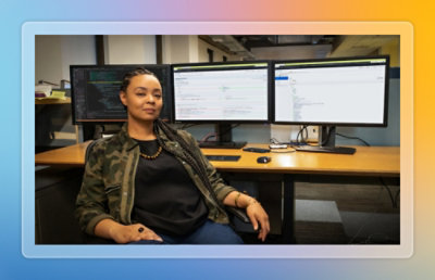 An image of an employee sitting in front of computer facing toward camera.